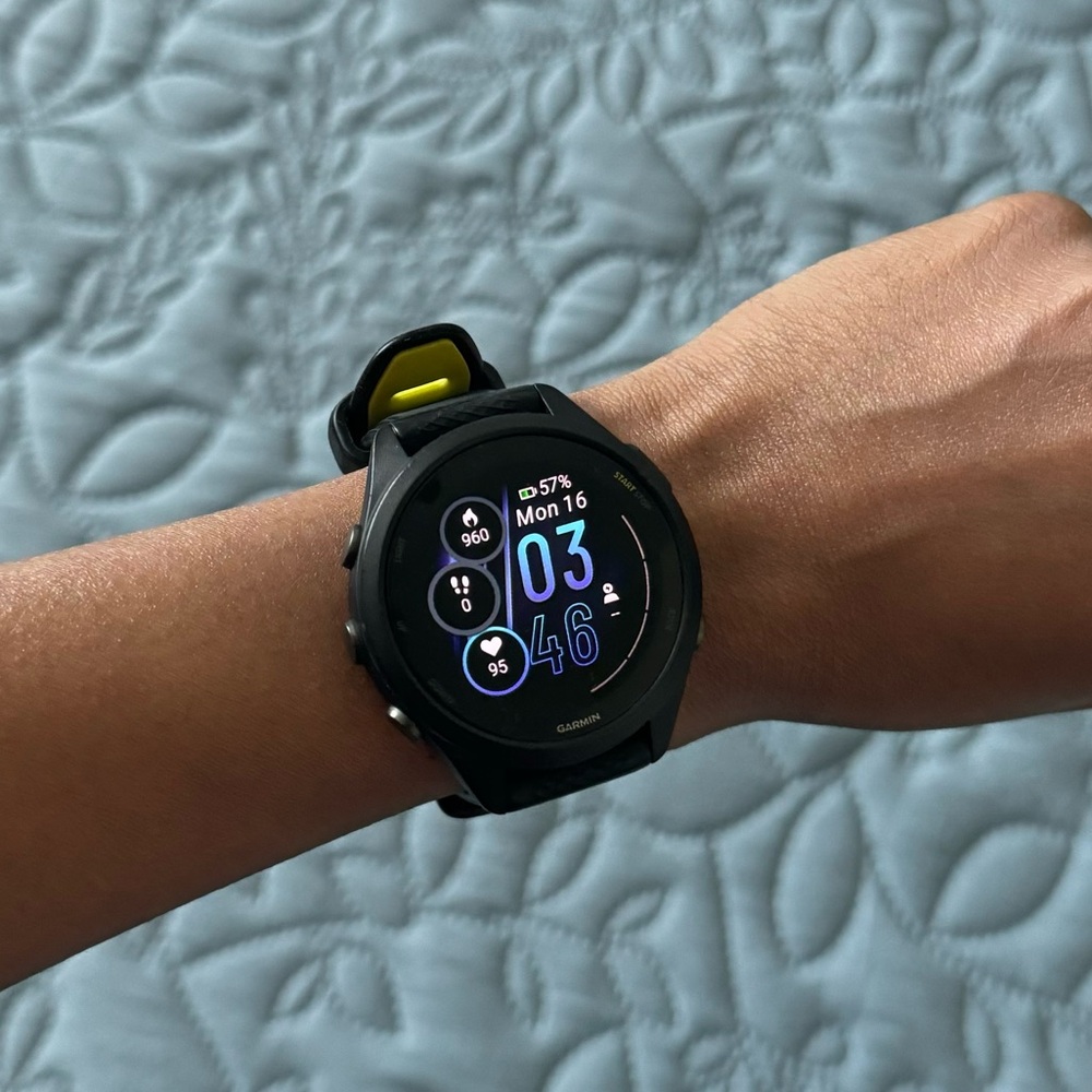 Garmin Forerunner 265s with green/black band.